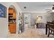 Inviting hallway with tiled flooring and a view into the kitchen at 18836 Green Park Rd, Hudson, FL 34667