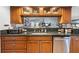 A kitchen featuring granite countertops, wooden cabinets, and stainless steel dishwasher at 18836 Green Park Rd, Hudson, FL 34667