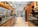 A kitchen with custom wood cabinets, stainless appliances and granite countertops at 18836 Green Park Rd, Hudson, FL 34667