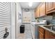 Functional laundry room with washer, dryer, cabinets, and closet for storage at 18836 Green Park Rd, Hudson, FL 34667