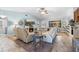 Cozy living room with a fireplace, ceiling fan, comfortable seating, and neutral decor at 18836 Green Park Rd, Hudson, FL 34667