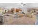 Carpeted open-concept living room with ceiling fan, recessed lights, kitchen and dining access at 18836 Green Park Rd, Hudson, FL 34667