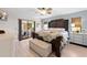 Spacious main bedroom with a large bed, sliding glass doors and natural light at 18836 Green Park Rd, Hudson, FL 34667
