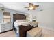 Light filled main bedroom boasting a cozy bed, woven blinds, and an en-suite bathroom at 18836 Green Park Rd, Hudson, FL 34667