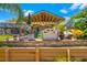 Relaxing outdoor bar area with multiple seating options, a grill, and space for kayaks at 18836 Green Park Rd, Hudson, FL 34667
