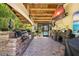 Inviting outdoor patio with a full kitchen, multiple grills, a bar, and a large screen TV at 18836 Green Park Rd, Hudson, FL 34667