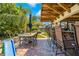 Covered outdoor patio with a dining table and chairs, bar seating, and access to the backyard at 18836 Green Park Rd, Hudson, FL 34667