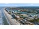 Panoramic aerial shot of a coastal city showcasing beach access, waterfront condos, and scenic ocean views at 19817 Gulf Blvd # 602, Indian Shores, FL 33785