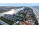 Expansive aerial view of a coastal community featuring waterfront condos, beachfront access, and stunning ocean views at 19817 Gulf Blvd # 602, Indian Shores, FL 33785