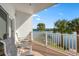 Relax on the covered balcony with serene water views and comfortable seating area at 19817 Gulf Blvd # 602, Indian Shores, FL 33785