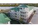 Exterior shot of a multi-story condo building with spacious balconies, offering stunning views of the surrounding landscape at 19817 Gulf Blvd # 602, Indian Shores, FL 33785