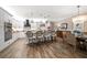 Bright, open kitchen featuring white cabinets, a black range hood, pendant lights, and island seating for four at 19817 Gulf Blvd # 602, Indian Shores, FL 33785