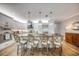 Well-lit kitchen with barstool seating at granite island, stainless appliances, and white cabinetry at 19817 Gulf Blvd # 602, Indian Shores, FL 33785