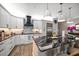 Open kitchen featuring white cabinetry, marble countertops, stainless steel appliances, and stylish pendant lighting at 19817 Gulf Blvd # 602, Indian Shores, FL 33785