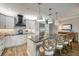 Spacious kitchen island with granite counters, pendant lighting, and bar stools at 19817 Gulf Blvd # 602, Indian Shores, FL 33785