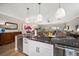 Kitchen with a large island with marble countertops and a wine fridge, open to living area with waterfront view at 19817 Gulf Blvd # 602, Indian Shores, FL 33785