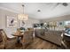 Inviting space with wicker chairs, a round dining table, and a plush beige sofa facing a bright outdoor view at 19817 Gulf Blvd # 602, Indian Shores, FL 33785