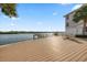 Gorgeous waterfront deck with private pier and outdoor dining area, perfect for relaxing and entertaining with scenic views at 19817 Gulf Blvd # 602, Indian Shores, FL 33785