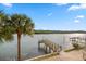 Breathtaking view of the water featuring a private dock and lush palm trees at 19817 Gulf Blvd # 602, Indian Shores, FL 33785