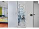 Hallway view of a retro blue tiled bathroom offering functionality and character at 2224 Gordon St, Tampa, FL 33605