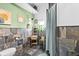 This bathroom features stone-tiled walls, modern fixtures, and plants at 2224 Gordon St, Tampa, FL 33605