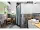 Modern bathroom featuring textured tile walls, a vessel sink, and decorative plants that add a touch of nature at 2224 Gordon St, Tampa, FL 33605