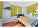 This bedroom features a single bed, an air conditioner, and an adorable, whimsical décor at 2224 Gordon St, Tampa, FL 33605