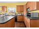 This kitchen has wooden cabinets, dark countertops and hardwood floors at 2224 Gordon St, Tampa, FL 33605