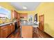 Bright kitchen features wood cabinets, hardwood floors, and an island with bar seating at 2224 Gordon St, Tampa, FL 33605