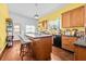 Cozy kitchen featuring wood cabinets, black appliances, and an island with seating at 2224 Gordon St, Tampa, FL 33605