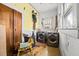 Functional laundry room with washer, dryer, storage, and quirky decor, blending practicality with a playful touch at 2224 Gordon St, Tampa, FL 33605