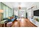 Cozy living room featuring hardwood floors, comfortable furnishings, and an abundance of natural light at 2224 Gordon St, Tampa, FL 33605
