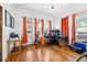Bright room with hardwood floors, orange curtains, large windows, and ample workspace and lighting at 2224 Gordon St, Tampa, FL 33605