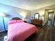 This bedroom features a pink bedspread and a wood dresser at 2253 Norwegian Dr # 63, Clearwater, FL 33763