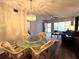 Inviting dining area with a glass table, wicker chairs, and views into the living room's comfortable seating at 2253 Norwegian Dr # 63, Clearwater, FL 33763