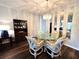 Elegant dining area with chandelier, mirrored accents, and wicker swivel chairs surrounding a glass-top table at 2253 Norwegian Dr # 63, Clearwater, FL 33763