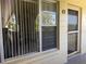 Ground level view of unit entrance with security features, light paint, and small number plaque at 2253 Norwegian Dr # 63, Clearwater, FL 33763