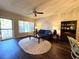 Cozy living room featuring a large window, ceiling fan, blue sofa, and a unique oval rug at 2253 Norwegian Dr # 63, Clearwater, FL 33763