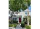 Charming two-story townhome featuring a red front door, gray siding and well-maintained landscaping at 244 Countryside Key Blvd, Oldsmar, FL 34677