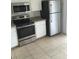 Functional kitchen featuring stainless steel appliances, neutral countertops, and ample cabinet space at 244 Countryside Key Blvd, Oldsmar, FL 34677