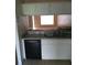 Kitchen with granite countertops, white cabinets, and an under-mount sink with view to the living area at 244 Countryside Key Blvd, Oldsmar, FL 34677