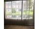 Room with large windows and blinds providing water views of community pond at 244 Countryside Key Blvd, Oldsmar, FL 34677