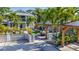 Landscaped backyard with patio, outdoor kitchen, covered parking, and lush greenery at 2635 13Th N Ave, St Petersburg, FL 33713