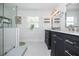 Bright bathroom features a glass shower, dual vanities, and stylish modern fixtures at 2635 13Th N Ave, St Petersburg, FL 33713