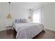 Inviting bedroom with wood floors, pendant lighting, and soft, neutral bedding at 2635 13Th N Ave, St Petersburg, FL 33713