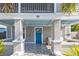 Charming front porch with patterned tile, blue door and ceiling, and modern seating area at 2635 13Th N Ave, St Petersburg, FL 33713