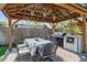Outdoor gazebo with a dining table set, grill, and tile countertop, perfect for entertaining at 2635 13Th N Ave, St Petersburg, FL 33713