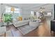 Bright and airy living room showcasing modern decor, hardwood floors, and seamless flow to the kitchen at 2635 13Th N Ave, St Petersburg, FL 33713