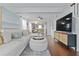 Open living area featuring hardwood floors, a comfortable sofa, and a view into the kitchen at 2635 13Th N Ave, St Petersburg, FL 33713