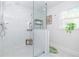 Modern shower with white subway tile, glass enclosure, and a view to a patterned window at 2635 13Th N Ave, St Petersburg, FL 33713